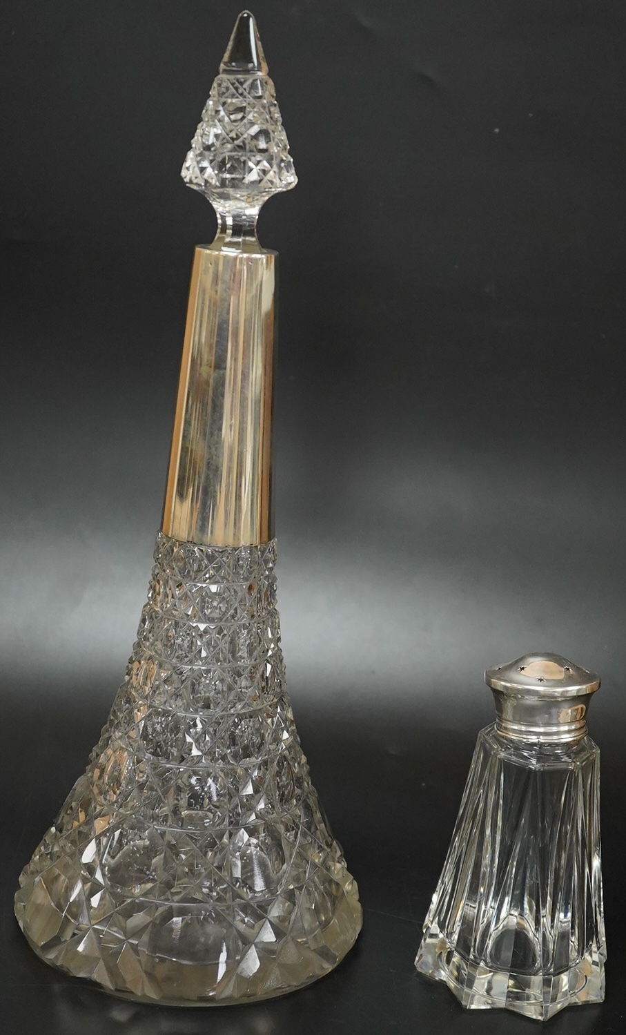 A German 800 standard white metal mounted cut glass decanter and stopper, overall height 36.5cm, together with a George VI silver mounted glass sugar caster.